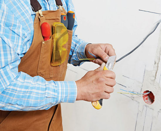 Electrician wiring outlet.